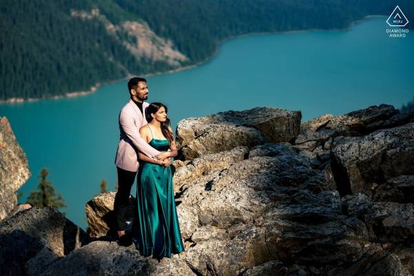 Man hugs his fiancée during engagement session at Peyto Lake.