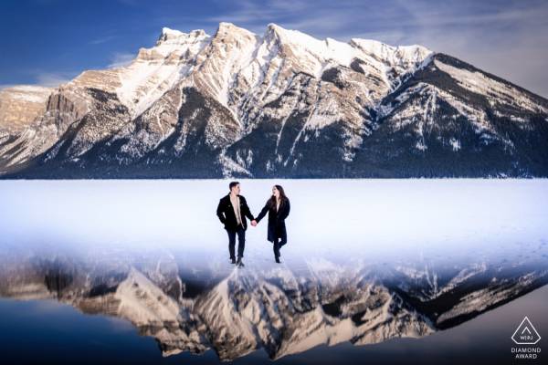 Award Winning Photograph taken by Banff Wedding Photographer of the engaged couple walking in the mountains.