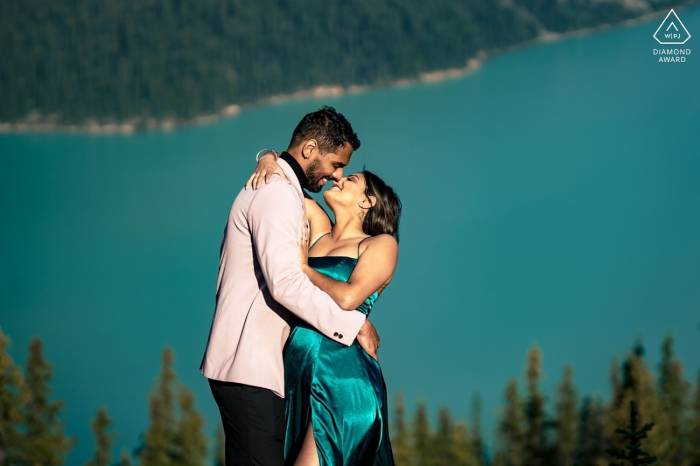 Handsome couple go for a kiss during engagement session in Banff