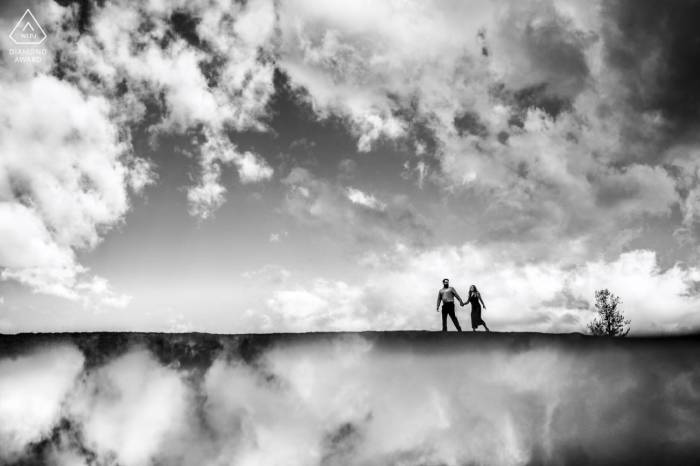 Incredibly creative award-winning photograph of the couple walking in the clouds.