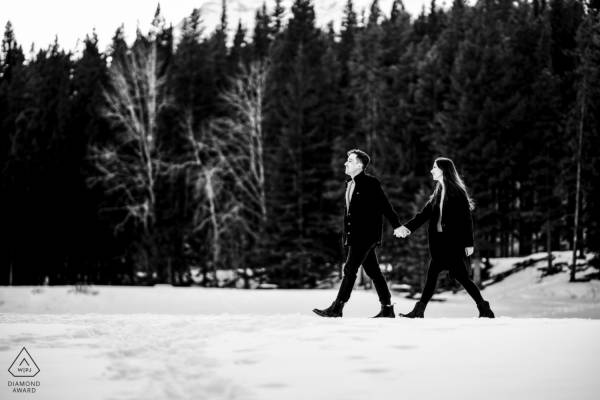 Award Winning Photograph of the couple in love walking in the forest.