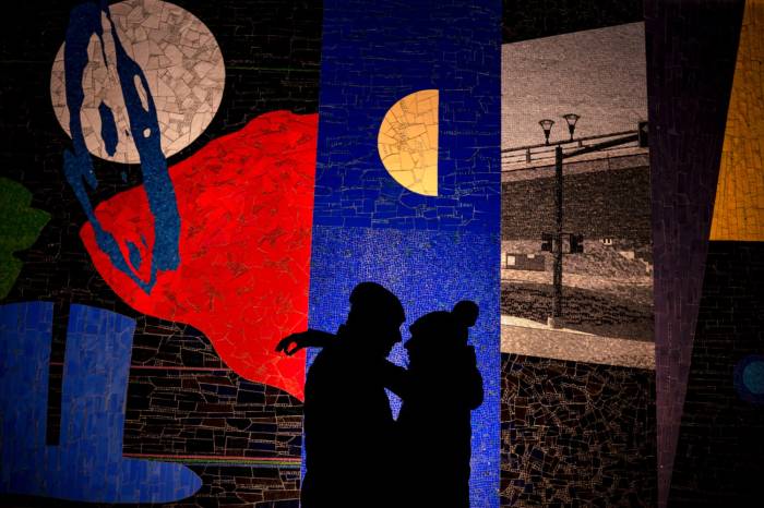 Incredible creative photograph of silhouette couple in love against mosaic wall in Calgary.
