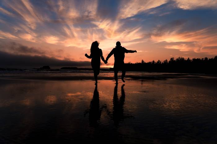 Couple in love is running on the beach in Banff National Park