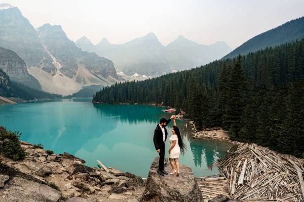 Couple is dancing on the rock during while Banff Wedding photographer capture this romantic moment.
