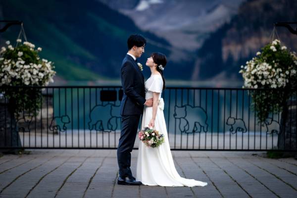 Bride and groom in a hug, facing each other at the majestic location Lake Louise I Banff. Intimate moment captured by Banff Wedding Photographer.