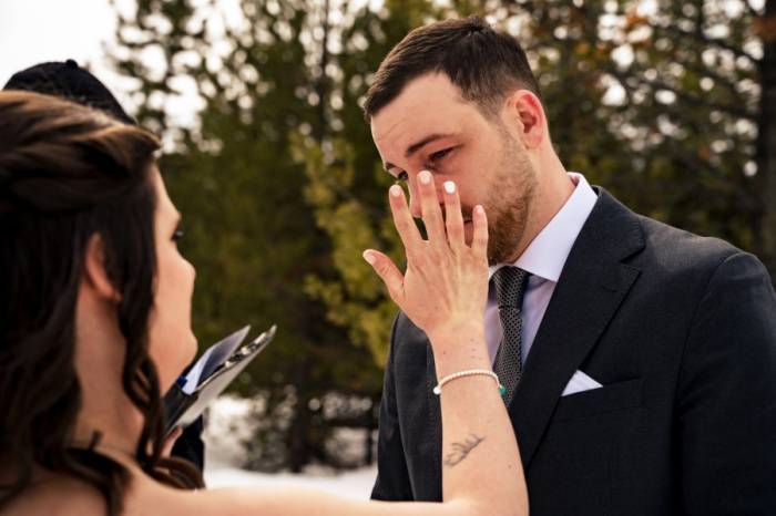 Bride wipes the groom's tear from his cheek during Calgary Wedding Ceremony.