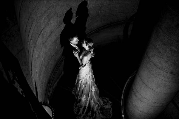 Bride and groom in the dark corridor on the stairs in Fairmont Banff Springs hotel.