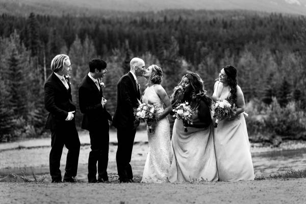 Bride maids and groom maids looking at newlyweds during Canmore bridal party.