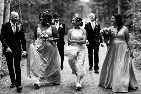 Bridal Party walks and have hun in Canmore. Everyone talks and laugh.