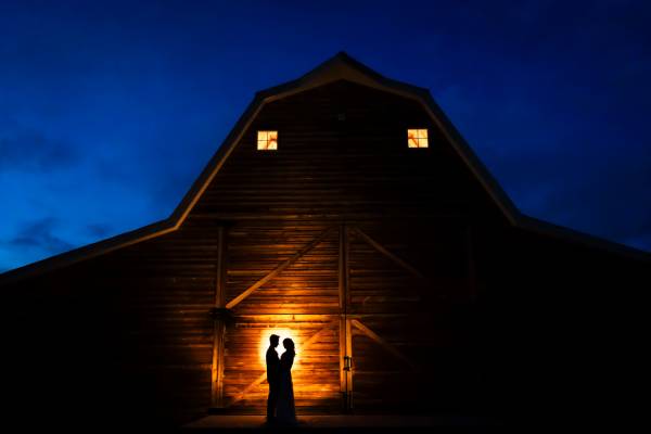 Calgary Night Wedding Photography of the silhouetted couple against the shed.