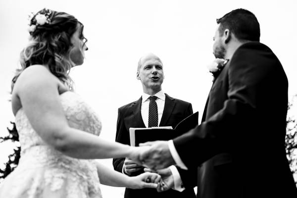 Officiant marry the bride and groom . Photo in black and white by Banff Wedding Photographers.