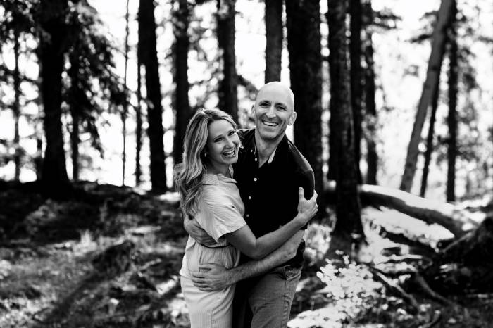 Engaged couple having fun during their engagement session at Minnewanka Lake