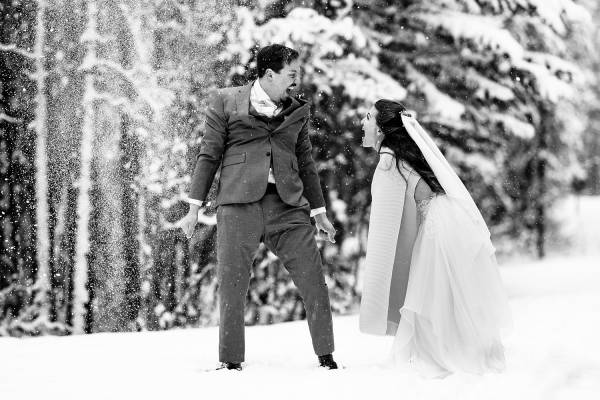 Newlyweds are having fun in the snow