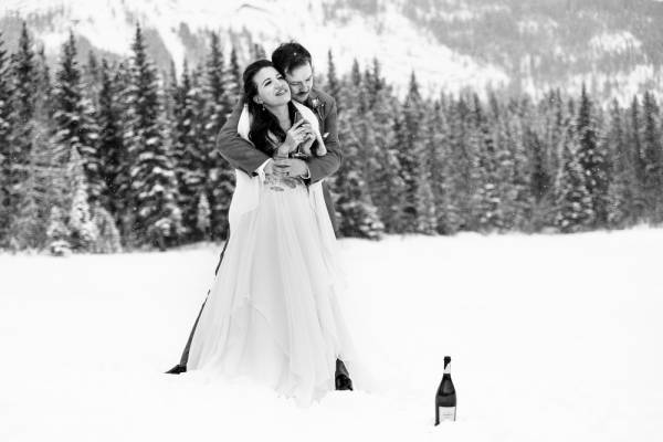 Groom hugging the bride during winter photo session in Kananaskis Alberta
