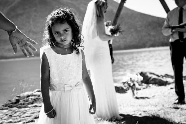 Cute child look at the camera during wedding ceremony in Banff at Minnewanka Lake