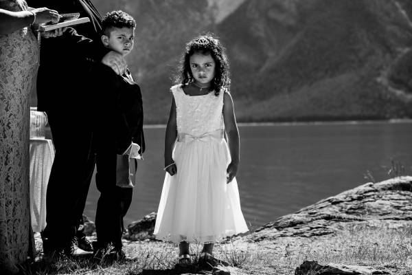 Bride's children's during elopement ceremony looking at the camera. Black and White photo.