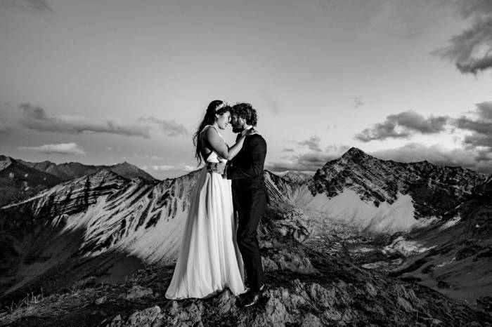 Bride and Groom touches their foreheads and look into eyes during Mountain Adventure Photo Session in Banff National Park.