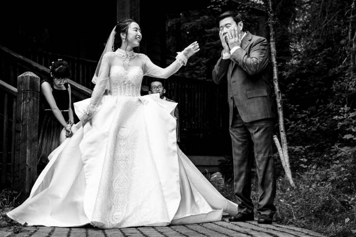 Bride's father cries before wedding while the bride tries to cheer him up.