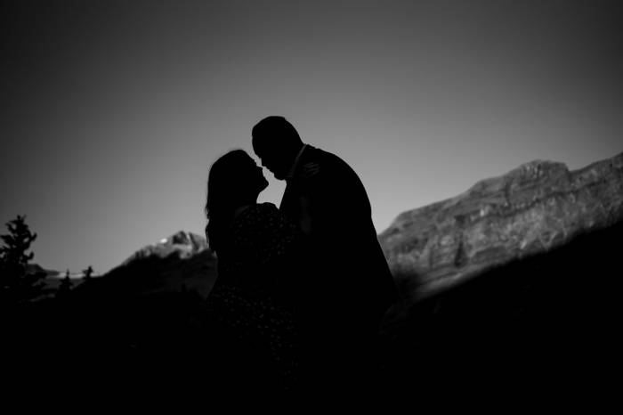 Banff engagement announcement during engagement photo session of silhouette couple in the mountains.
