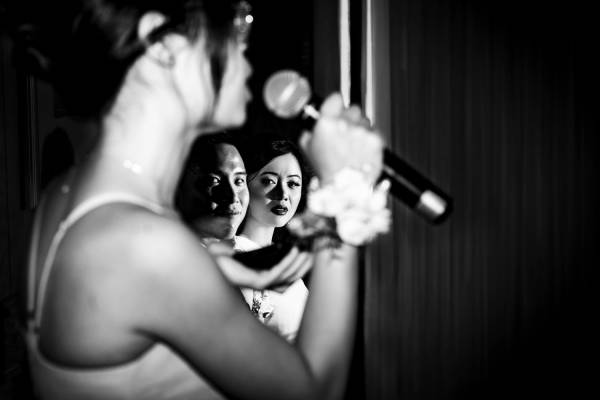 Creative Banff Wedding Photography of the bridemaid giving a speech. Photography than through her hand whit the microphone.