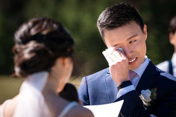 the groom wipes his tears during touching bride's speech at the banff wedding ceremony.