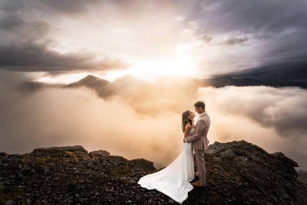 Wedding couple embracing in front of breathtaking Banff scenery, capturing their special day in the majestic Canadian Rocky Mountains during stunning sunset.