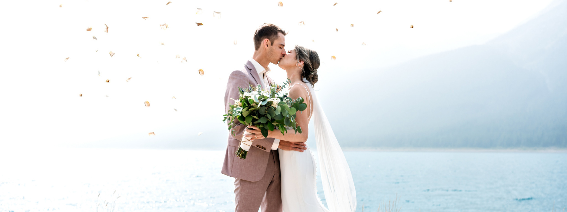 Bride and groom's first kiss after wedding ceremony in Banff | 4Eyes Photography
