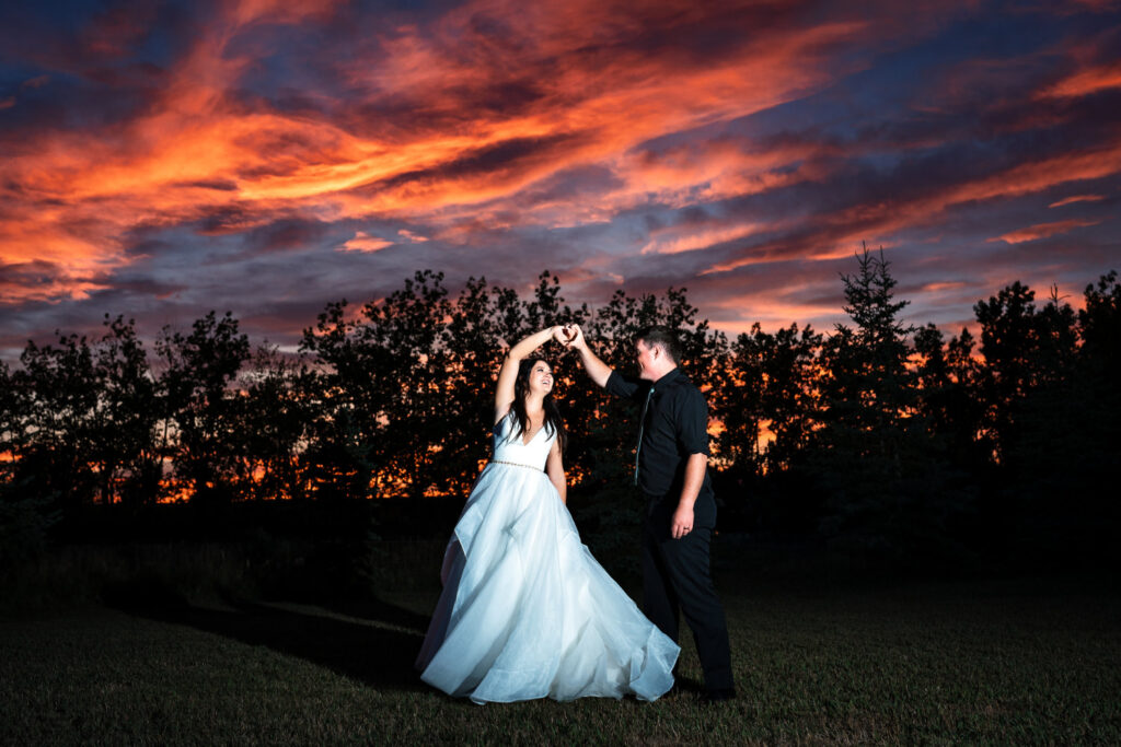 Calgary Wedding Photography of the bride and groom dancing during sunset | 4Eyes Photography