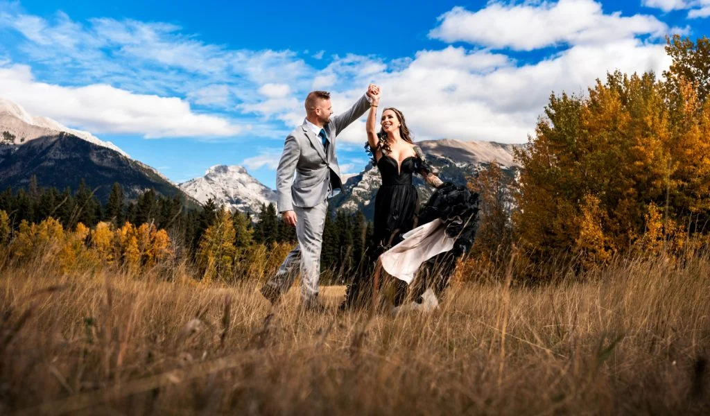 Groom's spinning the bride during portrait session in Canmore