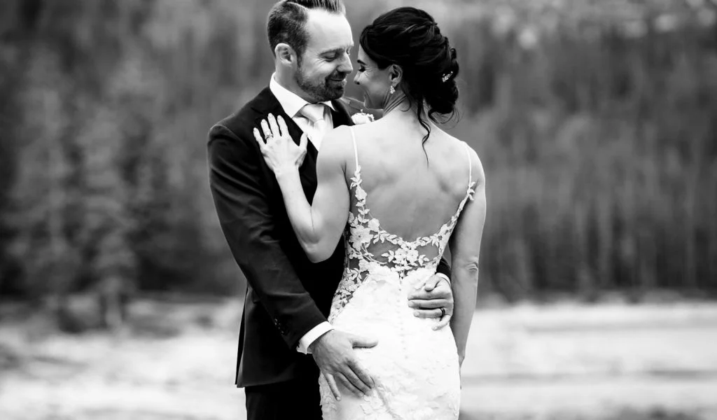 Bride and groom hug during wedding portrait session