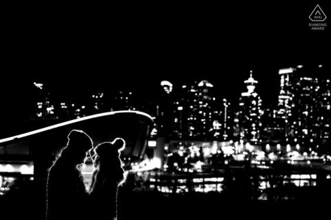 backlighted couple in love against stunning city of Calgary