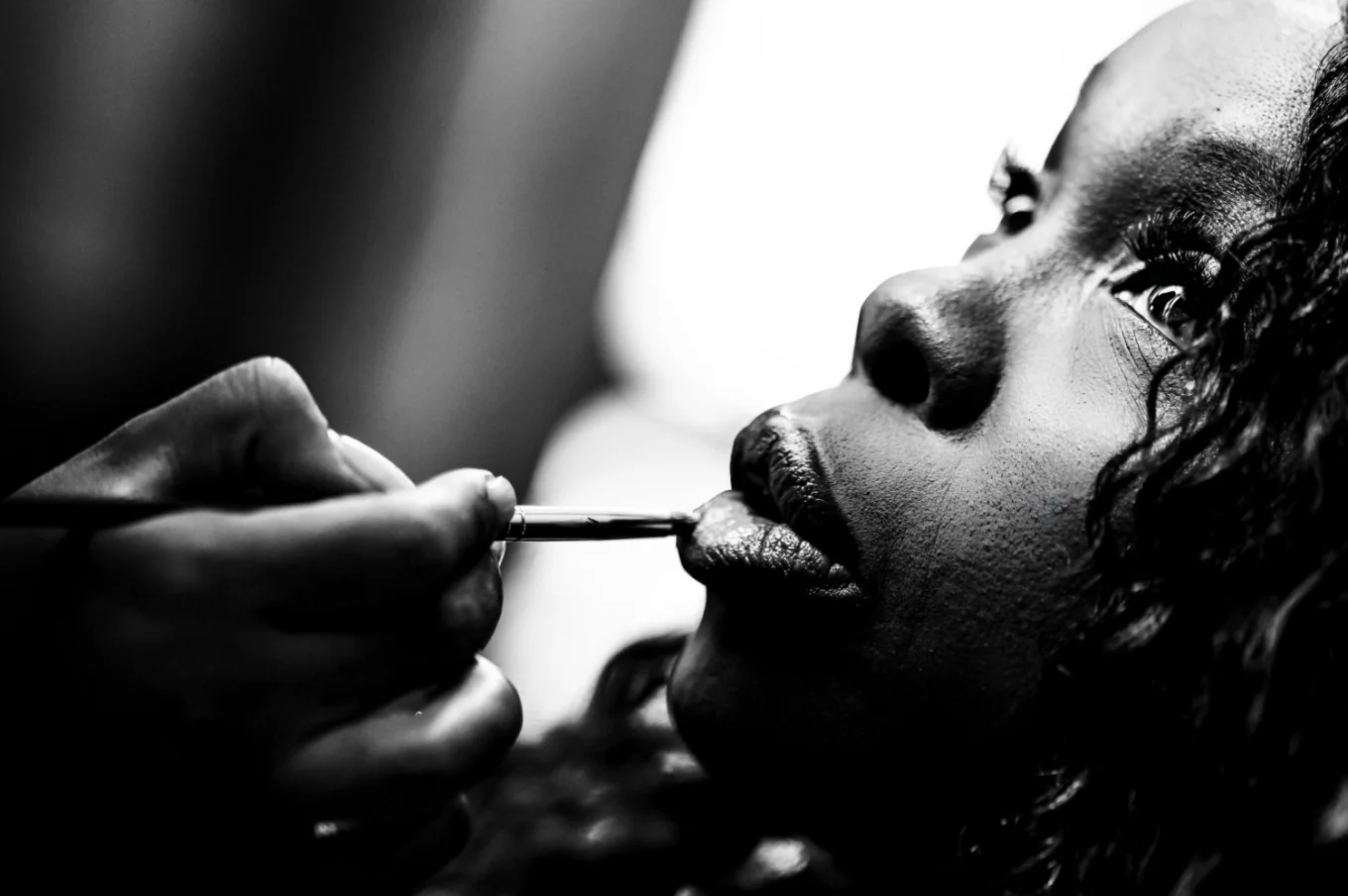 Creative photograph of the bride getting make up before the wedding in Calgary.