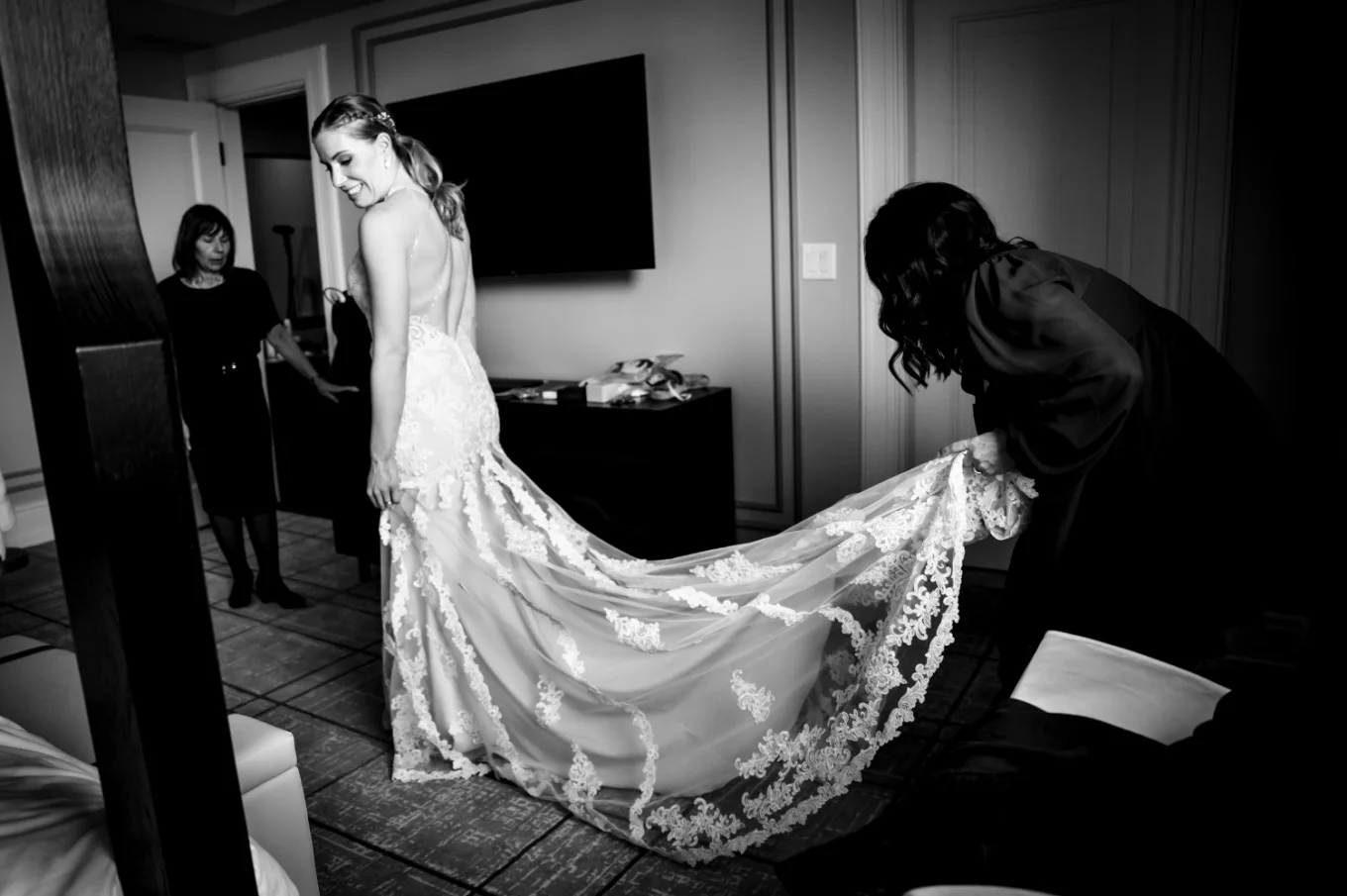 Banff Wedding Photography in black and white of the bride and her sister fixing the wedding dress.