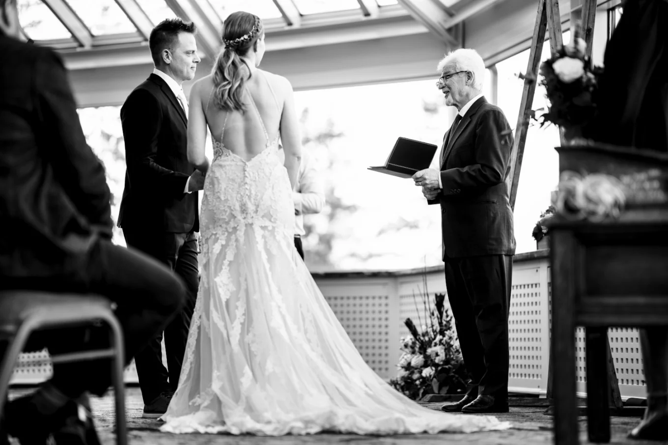The officiant giving a speech to newly-weeds at the Fairmont Wedding in Banff. Moment captured by Banff Wedding Photographer.