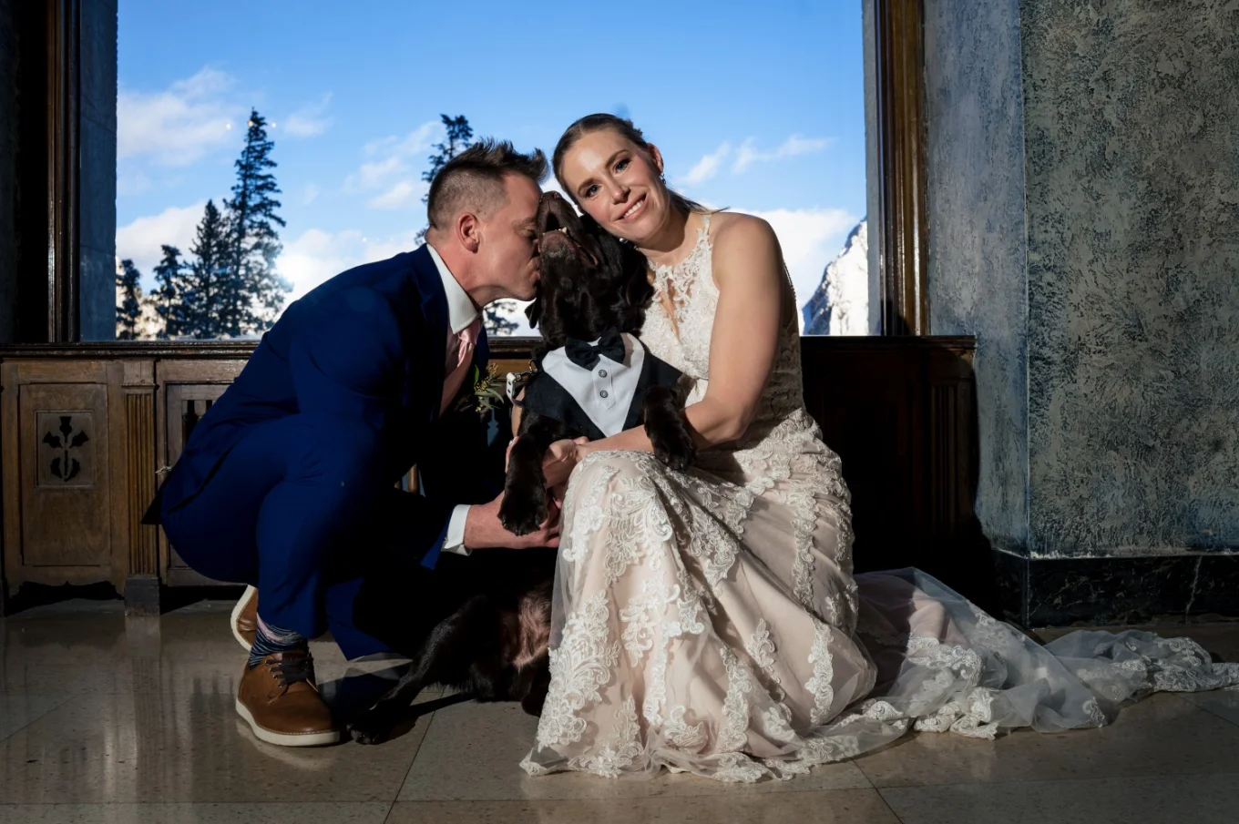 Bride and groom's portrait with their fur baby.