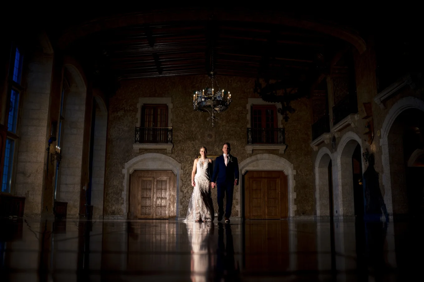 Bride and groom walk holding their hands at the ball room. Banfff Wedding Photography.