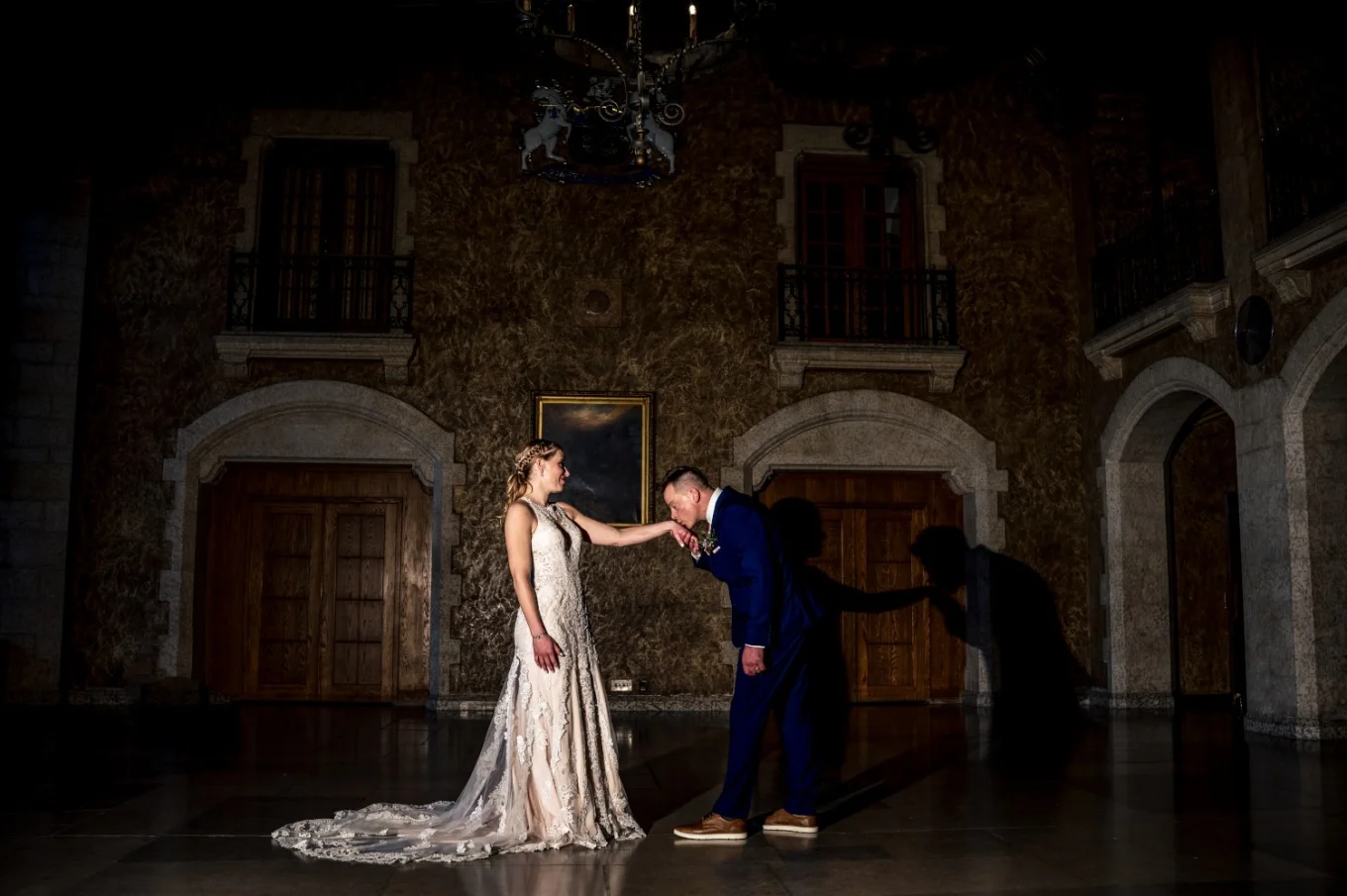 Groom kisses the bride's hand.