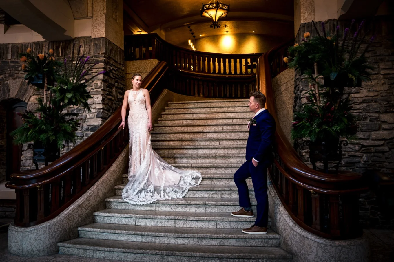 Newlyweds and the stairs looking at each other..