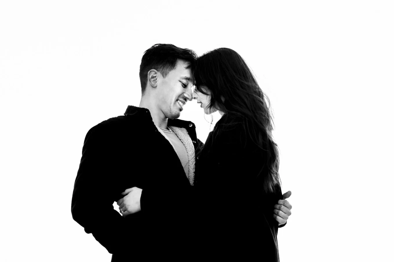 Black and white photograph of couple in love in intimate moment when they are about to kiss.