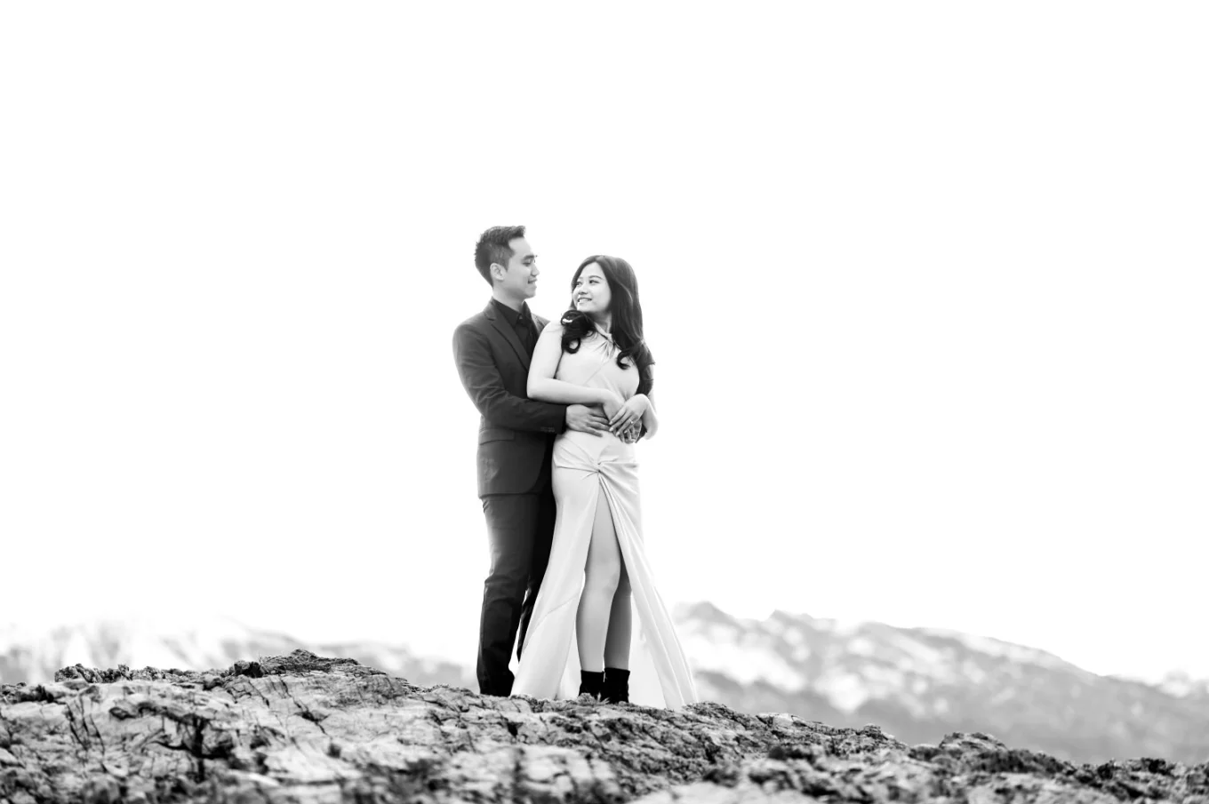 Photograph in black and white of the couple in love in a hug, looking at each other taken by Banff Wedding Photographer.