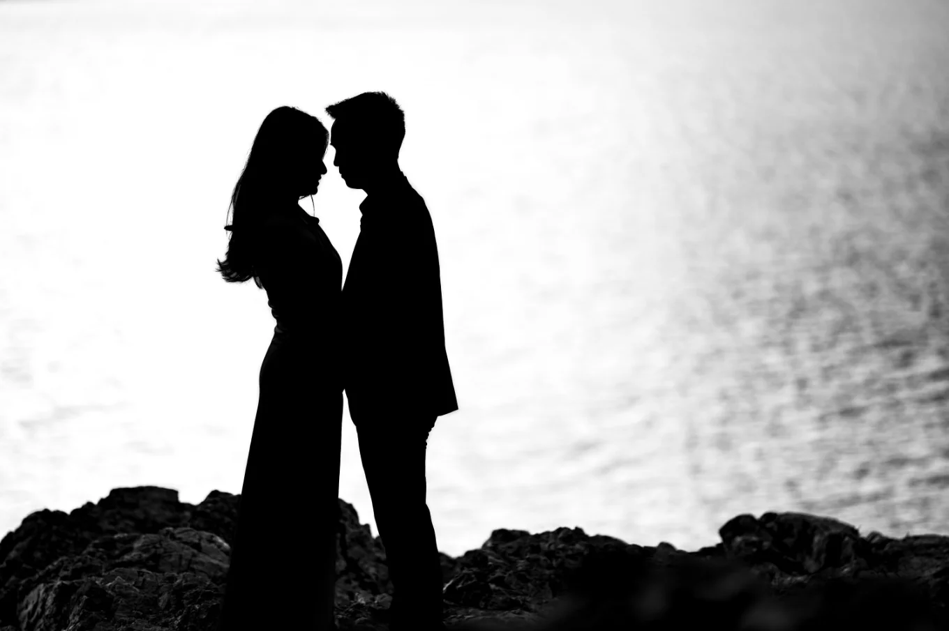 Creative silhouette the engaged could facing each other at Minnewanka Lake.