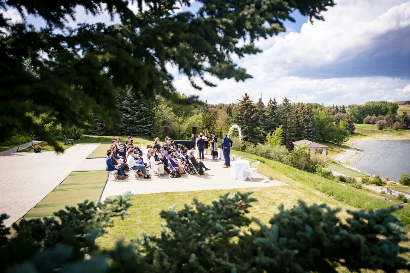Outdoor Wedding Ceremony in Calgary captured through the tree branches