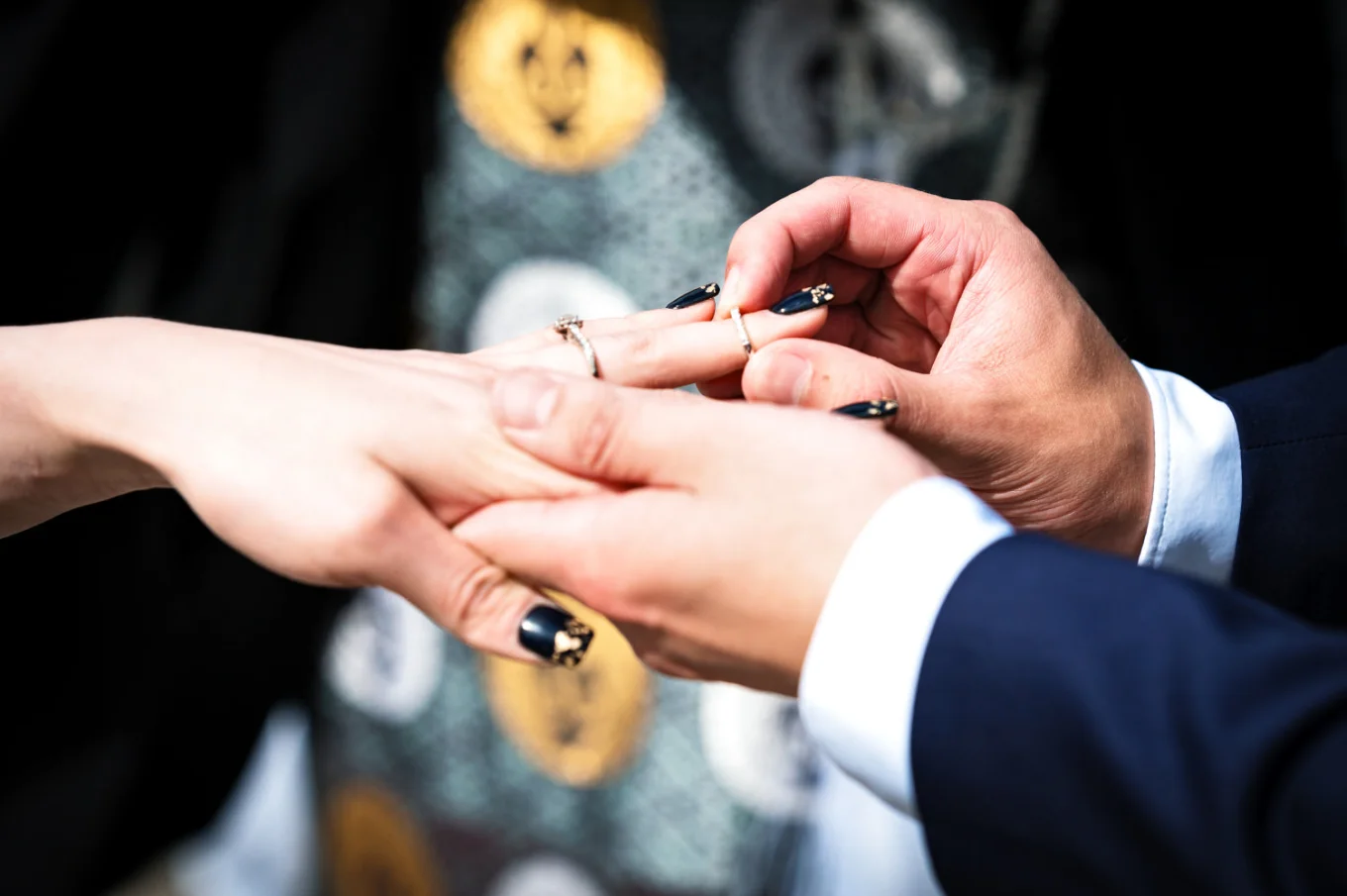 Bride's and Groom's hands on the Calgary Wedding Ceremony when the groom puts the wedding ring on the bride's hand.