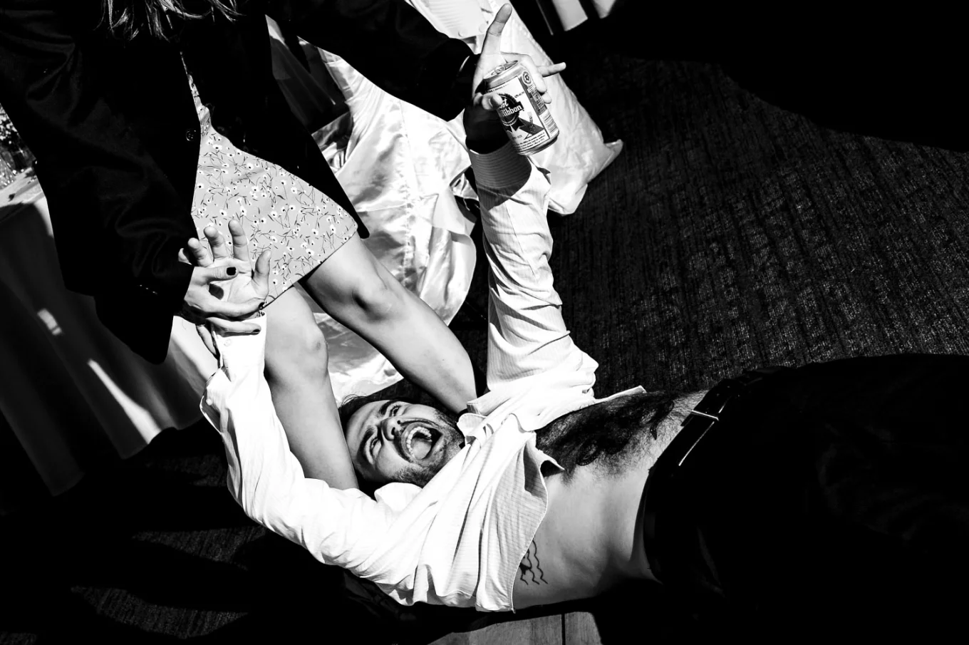 Wedding guest on the floor screaming as he can see his wife panties from that perspective.