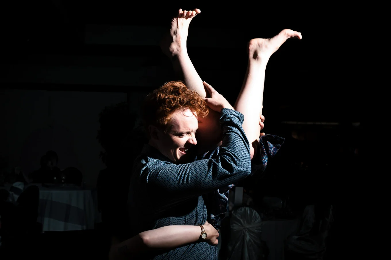 Man lifts his wife up. Her legs on the his head level. Crazy dance floor at the Calgary Wedding.