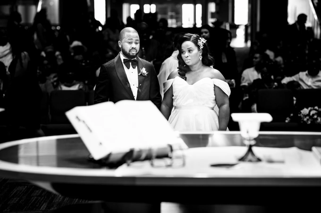 Bride and groom in front of altar I the church. On the altar the bible and vine.
