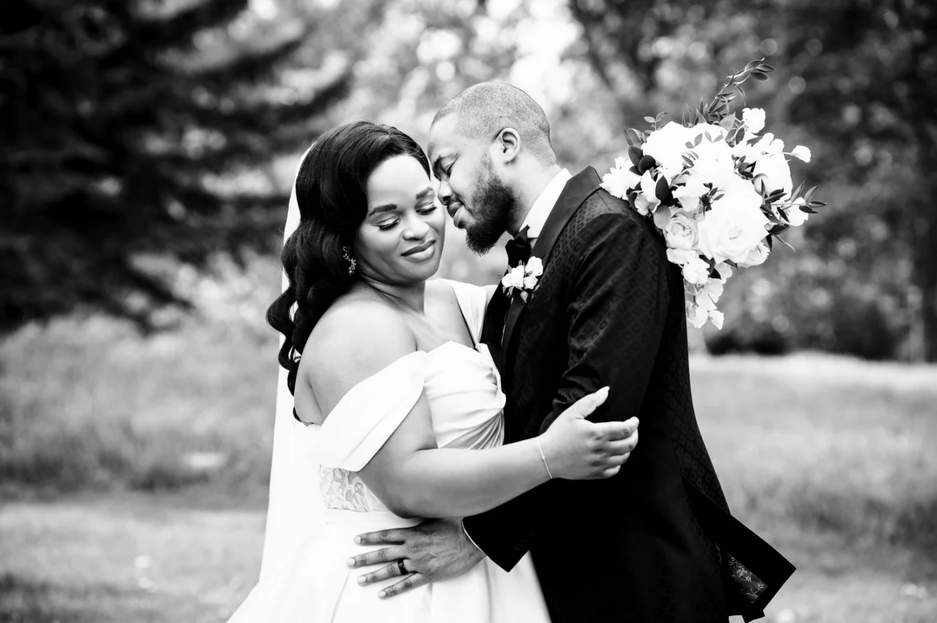 The groom try to kiss his wife on the neck. Romantic moment between the couple during portrait wedding session in Calgary.