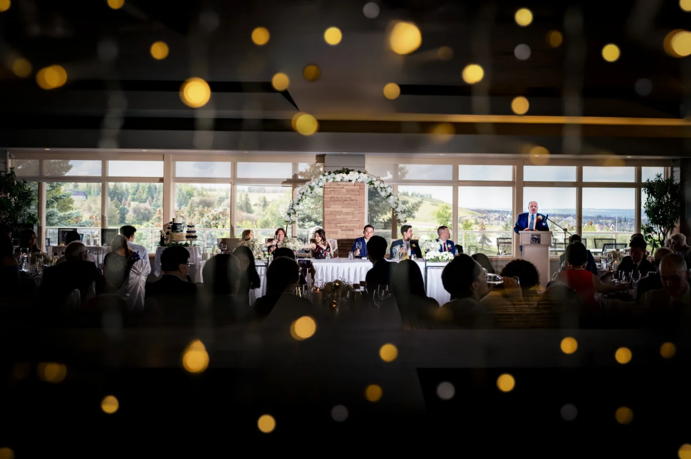Creative photograph on the wedding table at the wedding reception while the guests raise the glasses,