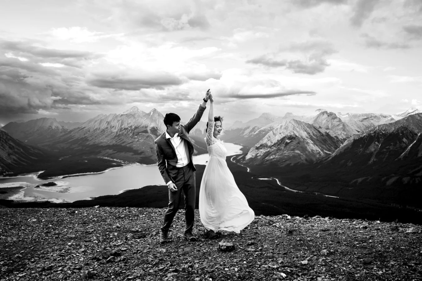 Newlyweds dance in the mountains. Moment captured by Banff Wedding Photographer.