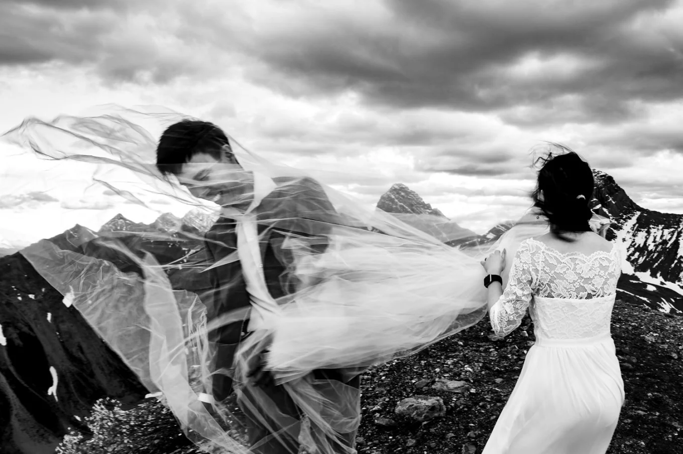 The bride's veil covered all the groom. Funny photograph on the windy day.